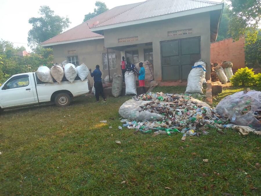 Collected plastic waste in large bags being delivered by pickup truck